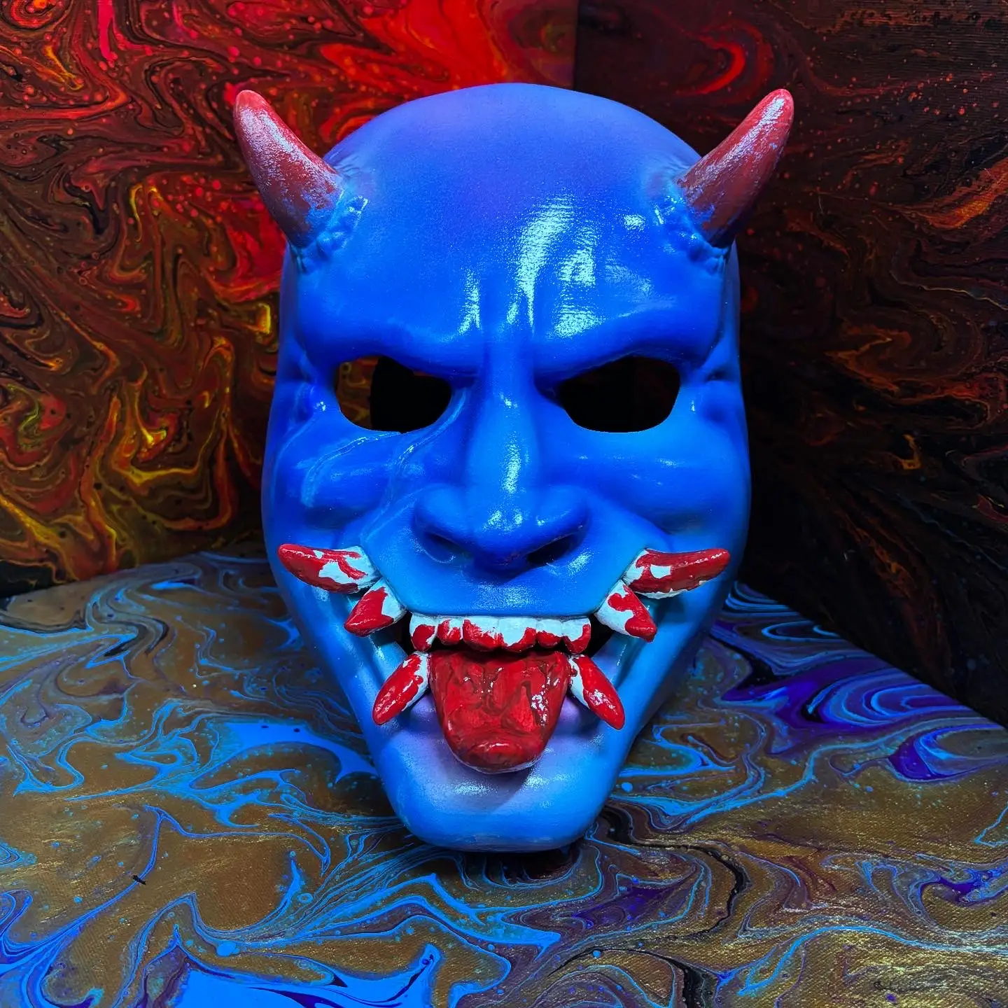 Glossy blue Oni mask with bold contrast and detail