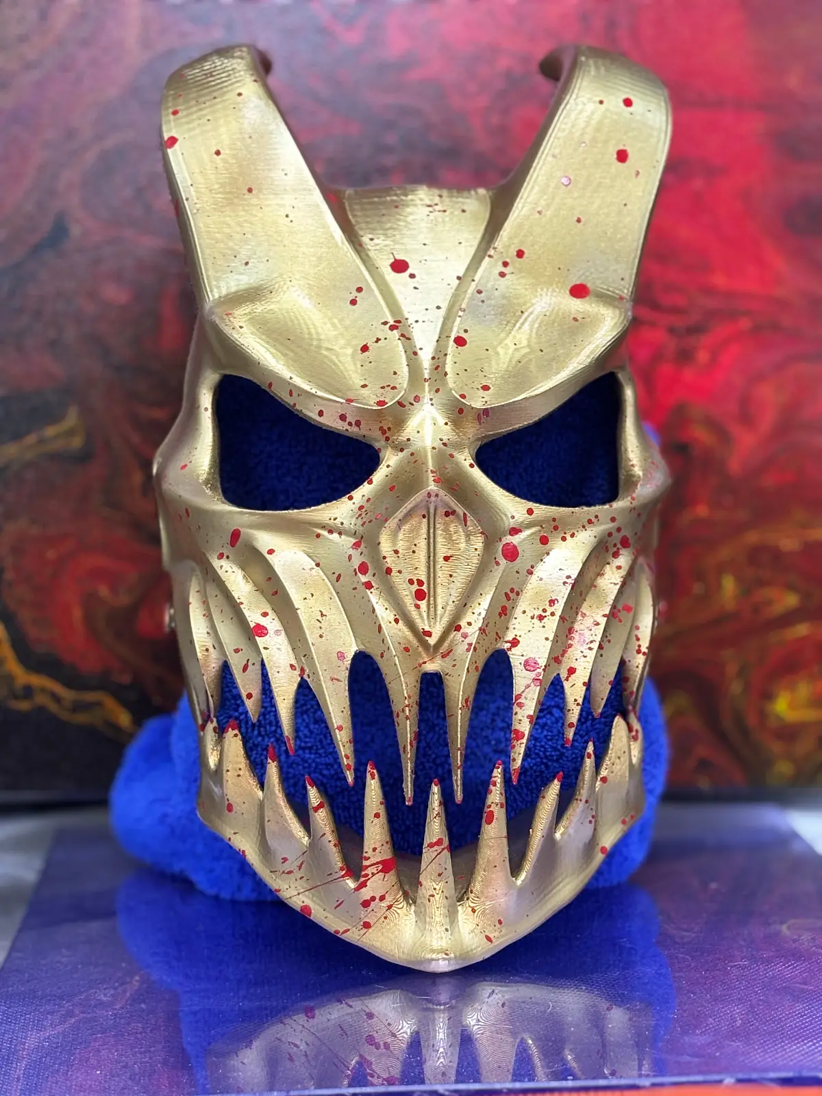 Metallic gold skull-style mask with aggressive sculpt